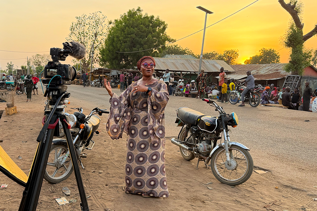 Habiba describes Sosai's impact during a video interview in Mararaban Demshin, Plateau State. 2026/08/sosai-story-street-scene.jpg